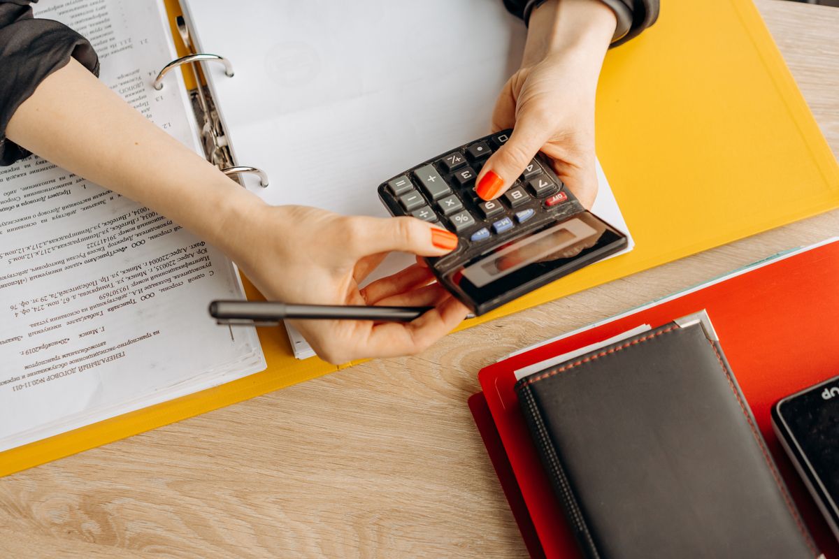 Bookkeeping workspace with a calculator, documents, and folders